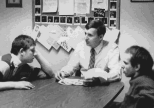 Dr. Michael McManmon pictured working with two young adults when CIP was first founded.